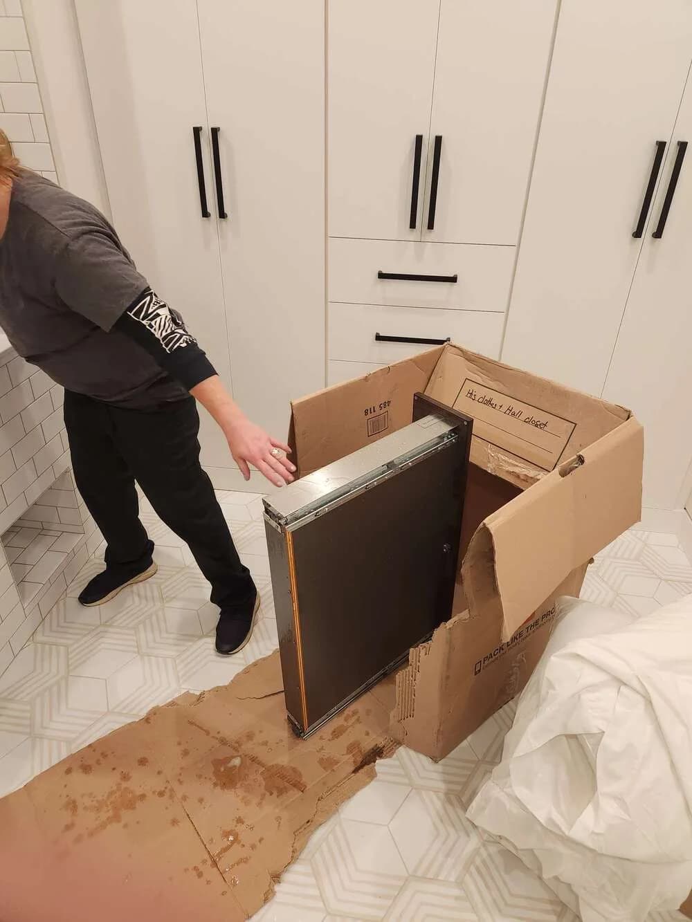 Removed cabinet drawer beside a technician during detailed cleaning
