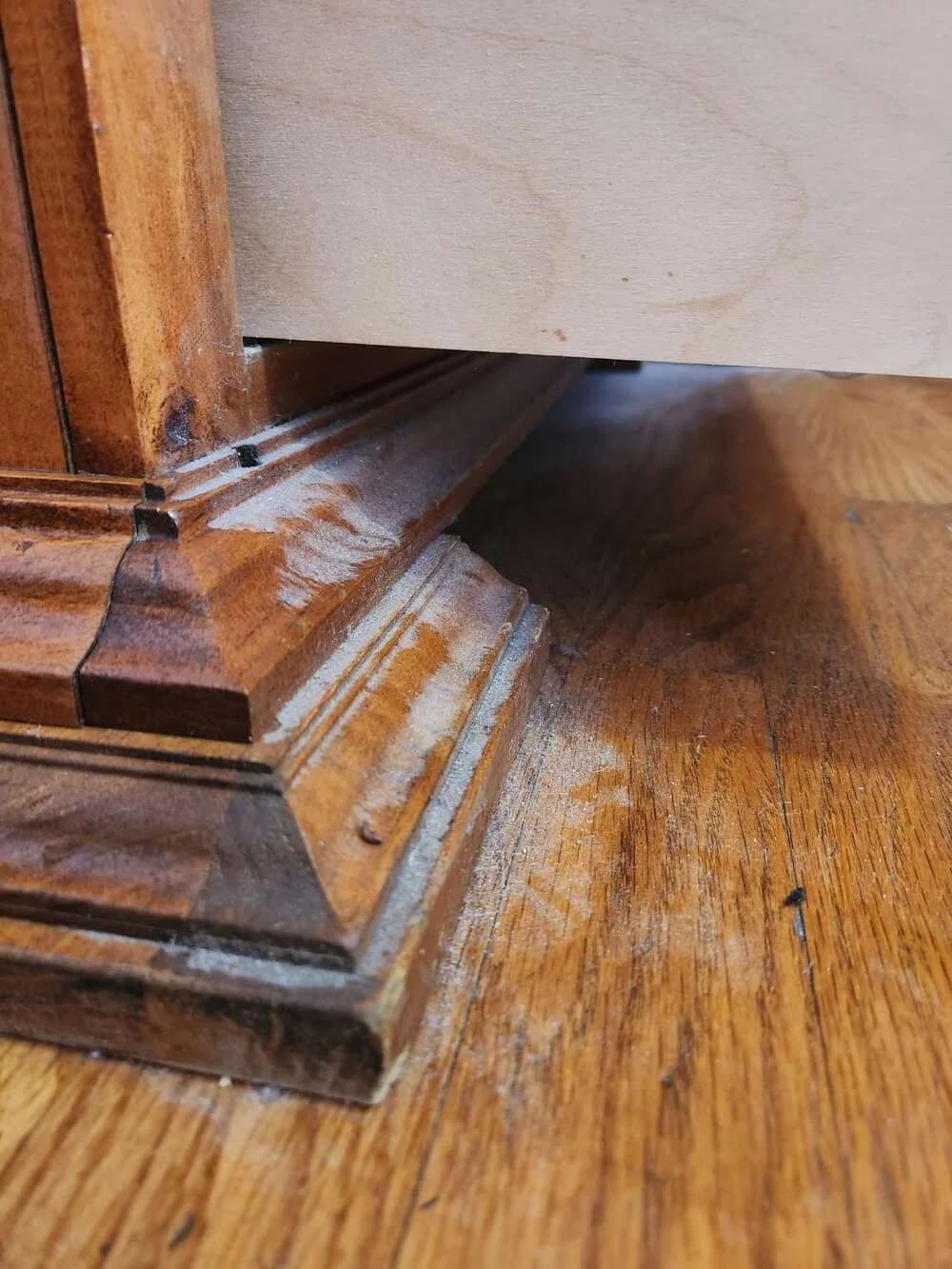 Wood trim and adjacent flooring during detailed cleaning